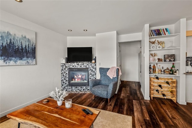 sitting room featuring a fireplace and dark hardwood / wood-style floors