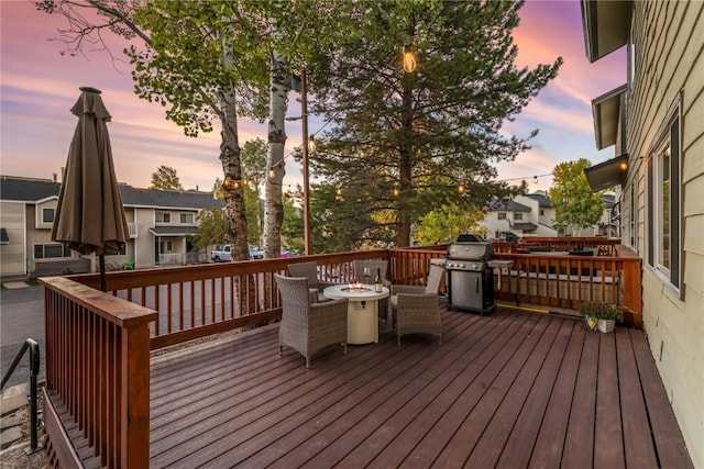 deck at dusk with grilling area