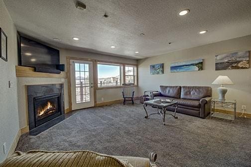 carpeted living room with a textured ceiling