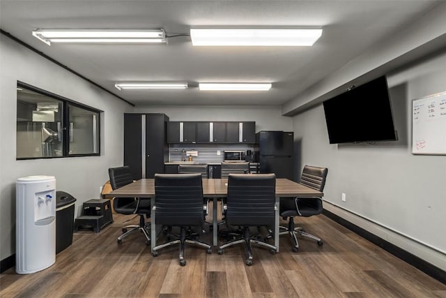 dining room with baseboards and dark wood-type flooring