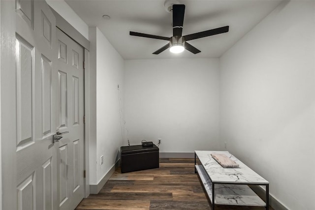 interior space featuring ceiling fan, dark wood finished floors, and baseboards