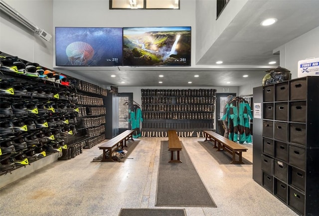 wine cellar with light speckled floor and recessed lighting