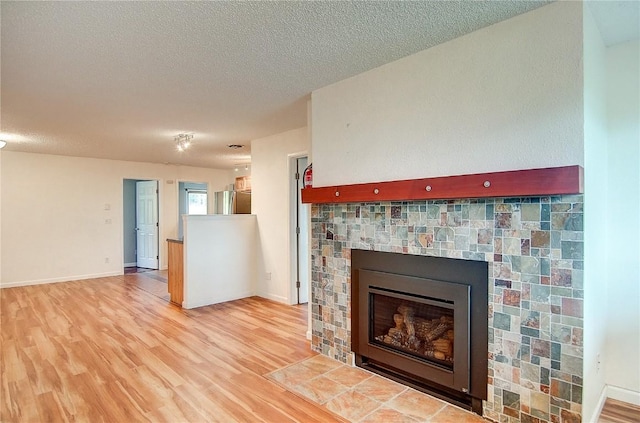 details featuring hardwood / wood-style floors, stainless steel fridge, a fireplace, and a textured ceiling