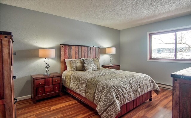 interior space with washer / dryer, a textured ceiling, and light hardwood / wood-style flooring