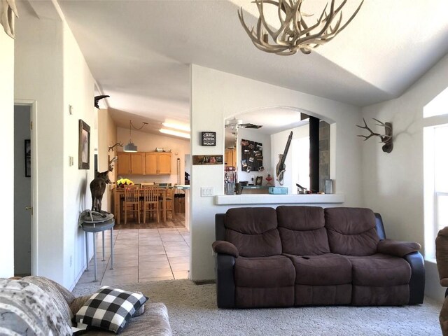 living room with light tile patterned flooring and lofted ceiling