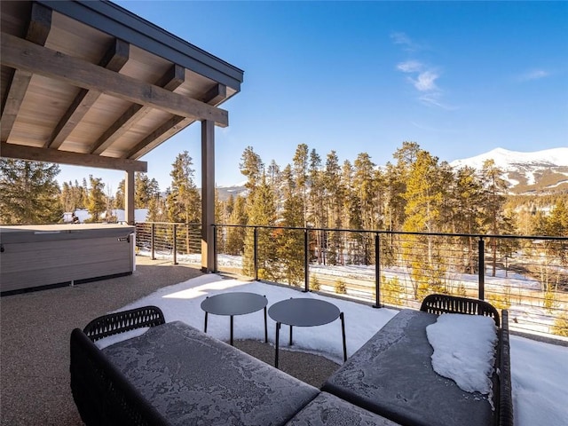 view of patio with a mountain view and a hot tub