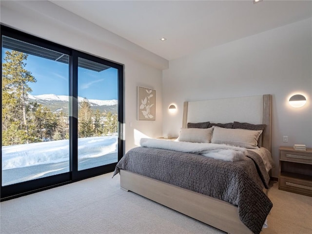 bedroom with access to exterior, a mountain view, carpet, and multiple windows