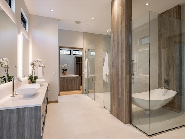 bathroom with tile patterned floors, vanity, and separate shower and tub