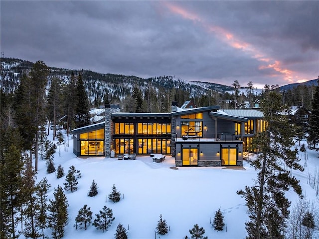 snow covered property featuring a mountain view