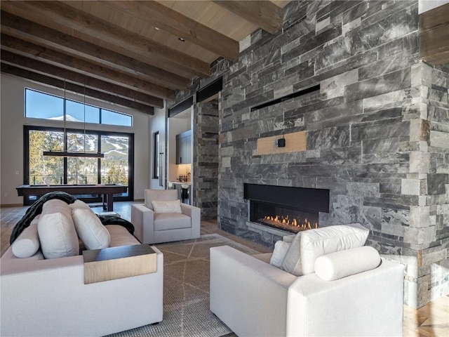 living room with wood ceiling, beam ceiling, high vaulted ceiling, billiards, and a fireplace