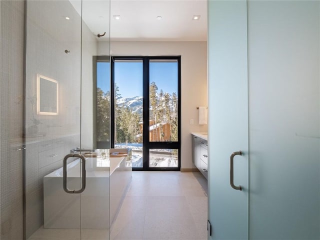 bathroom with vanity, a mountain view, and shower with separate bathtub