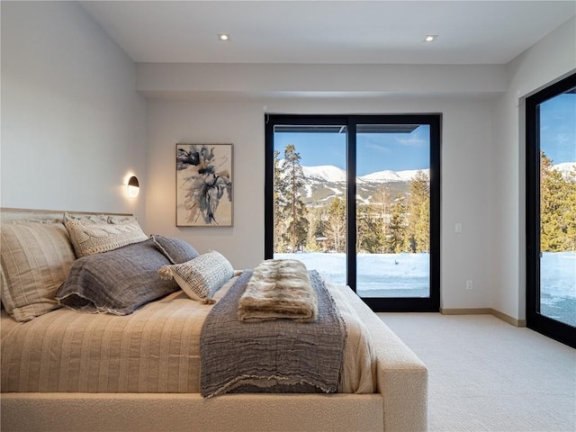 bedroom with access to outside, a mountain view, and light carpet