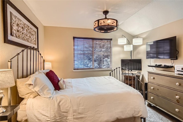 carpeted bedroom with vaulted ceiling