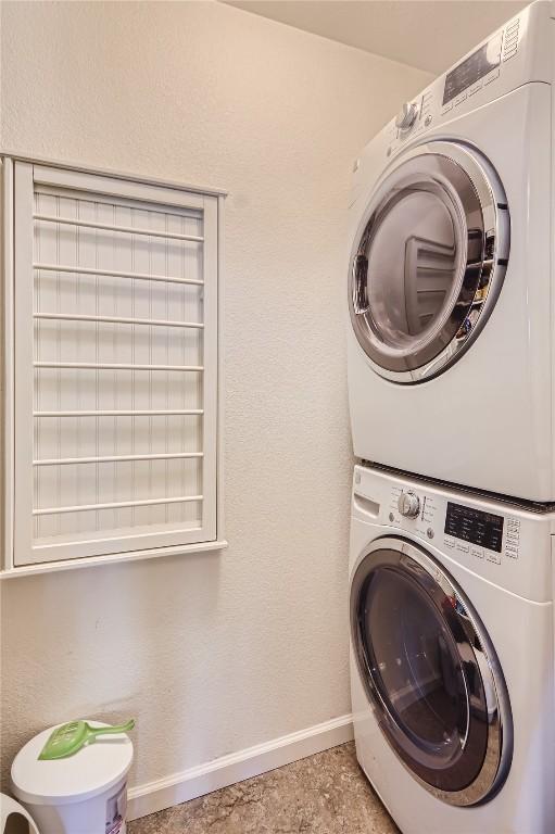 laundry area featuring stacked washing maching and dryer