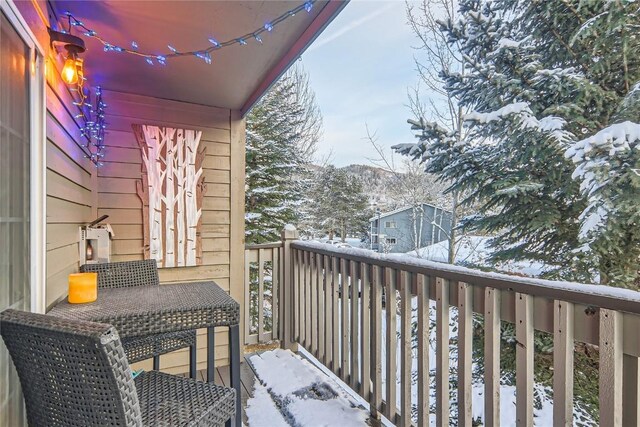 view of snow covered back of property