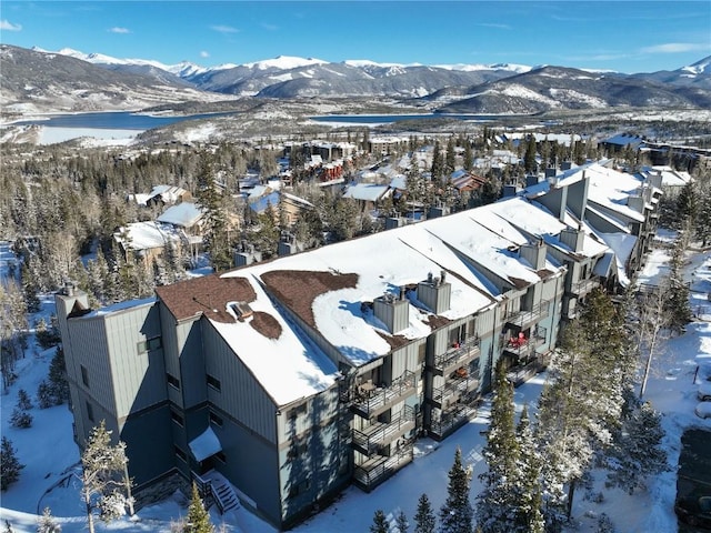 snowy aerial view with a mountain view