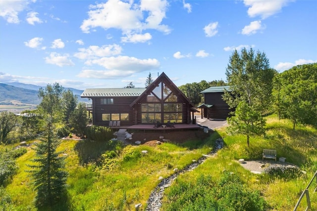 rear view of property featuring a mountain view