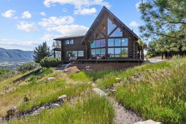 back of property featuring a mountain view