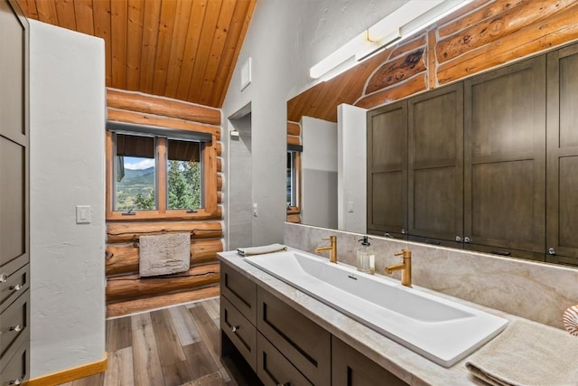 bathroom featuring rustic walls, vanity, wooden ceiling, hardwood / wood-style floors, and lofted ceiling