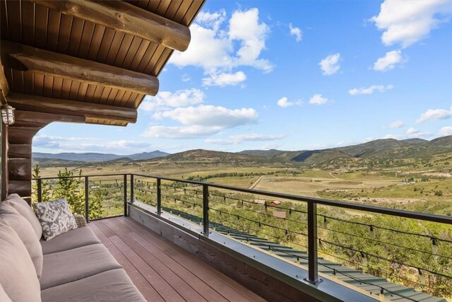 balcony with a mountain view, a rural view, and an outdoor hangout area