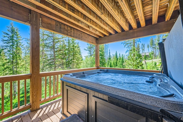 wooden deck featuring a hot tub