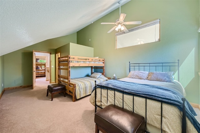 bedroom with ceiling fan, lofted ceiling, carpet floors, and a textured ceiling