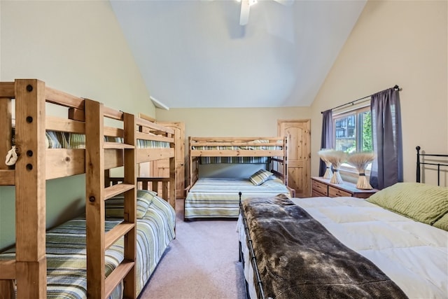 carpeted bedroom with high vaulted ceiling