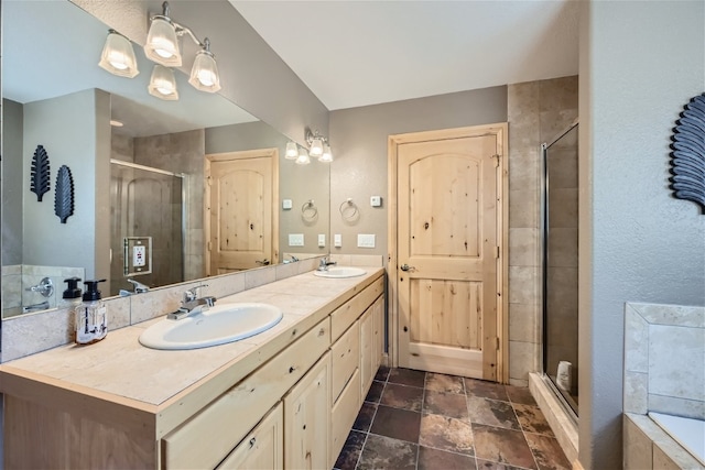 bathroom featuring shower with separate bathtub and vanity