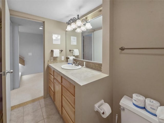 bathroom with tile patterned flooring, vanity, and toilet