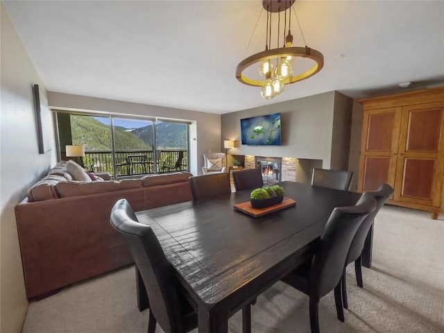 dining space with a notable chandelier and light colored carpet