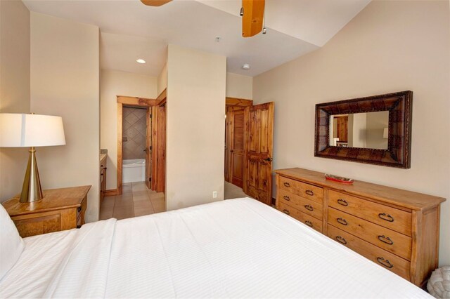 bedroom featuring connected bathroom, ceiling fan, and light tile patterned floors