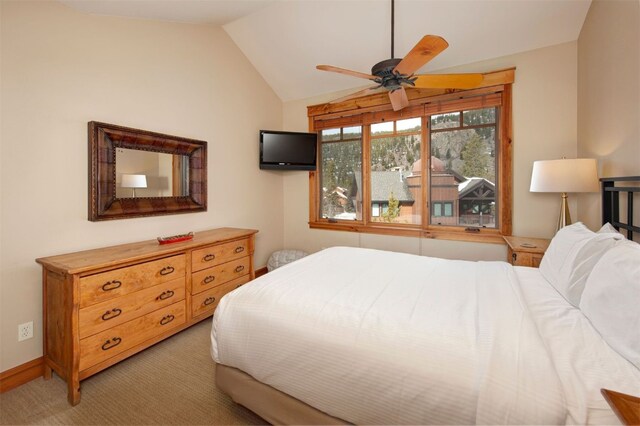 bedroom with lofted ceiling, baseboards, and light colored carpet