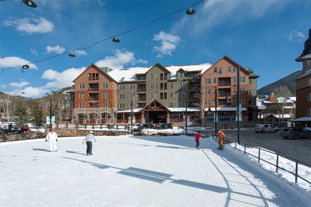 snow covered property with a mountain view