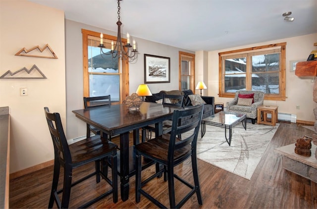 dining space featuring a baseboard radiator, dark hardwood / wood-style flooring, and a chandelier