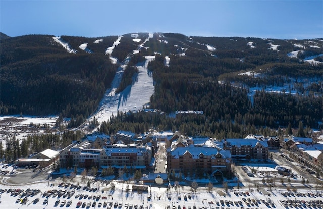 snowy aerial view with a mountain view