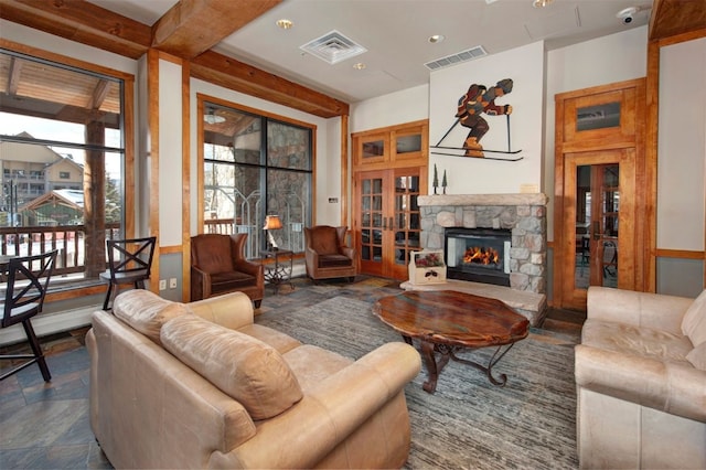 living room with a fireplace and beamed ceiling