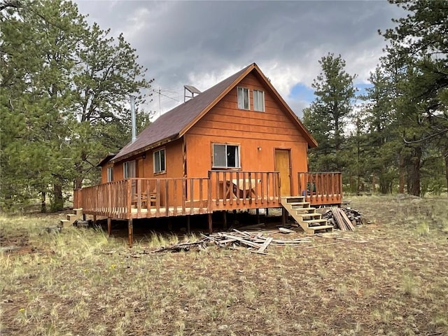 back of house featuring a wooden deck