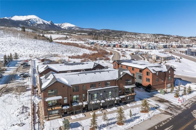 snowy aerial view with a mountain view