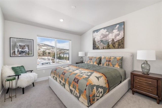 bedroom featuring a mountain view, light colored carpet, and vaulted ceiling