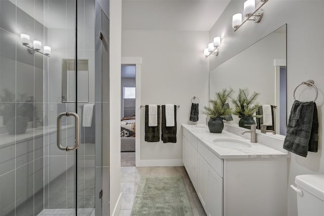 bathroom featuring tile patterned flooring, vanity, toilet, and a shower with shower door