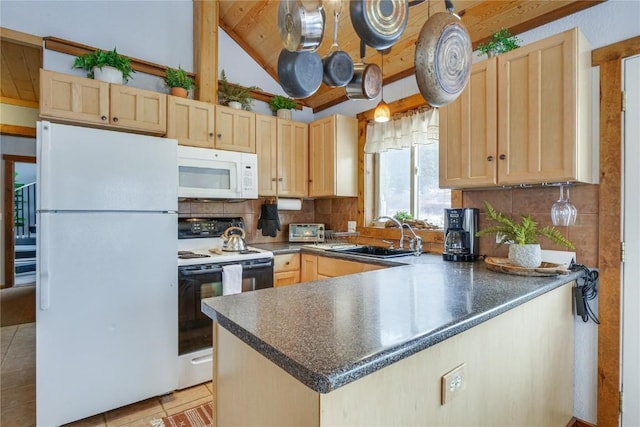 kitchen featuring light brown cabinetry, white appliances, and a sink