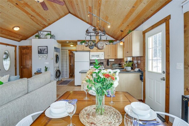 dining room featuring wooden ceiling, light tile patterned floors, stacked washer / drying machine, and high vaulted ceiling