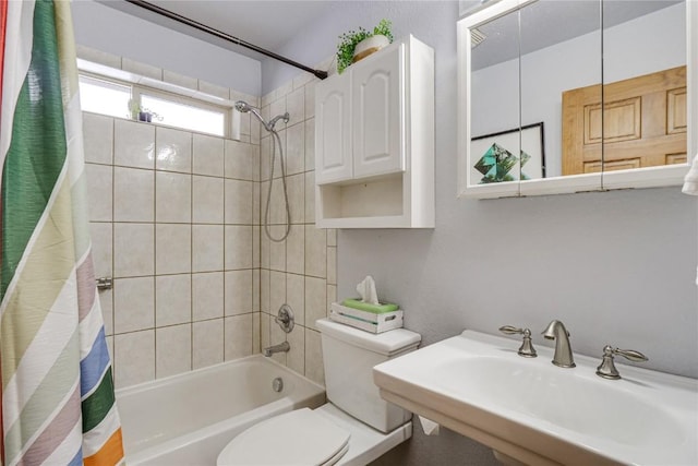 full bath with a sink, shower / bathtub combination with curtain, and toilet