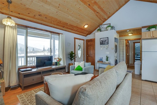 living room with wooden ceiling, stacked washer and dryer, light tile patterned floors, and high vaulted ceiling