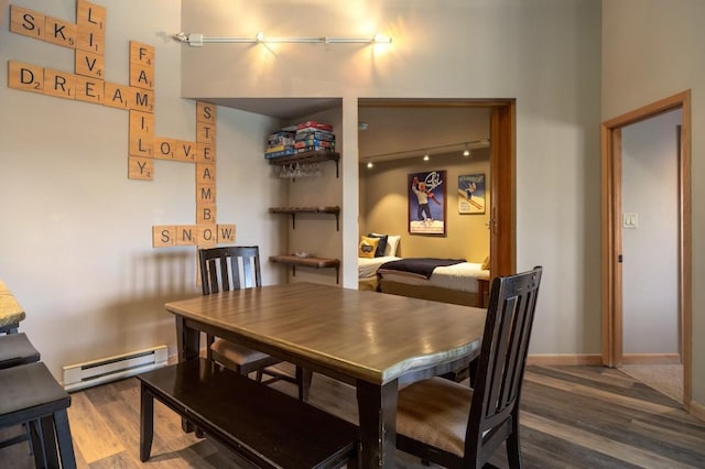 dining space with baseboard heating and wood-type flooring