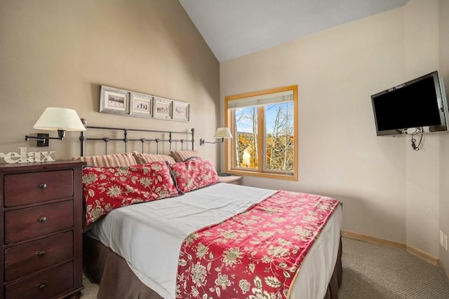 carpeted bedroom with lofted ceiling