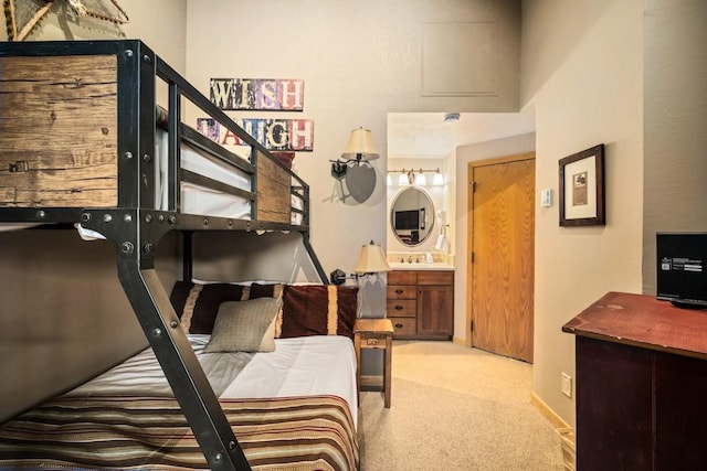 carpeted bedroom featuring ensuite bathroom