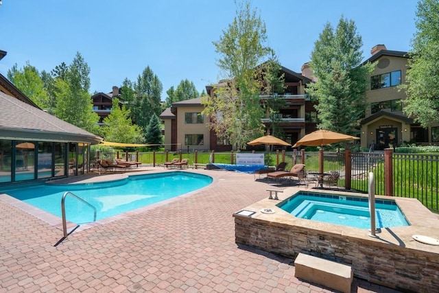 view of swimming pool featuring a patio area and a community hot tub