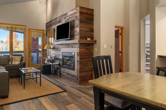 living room featuring a towering ceiling and wood-type flooring