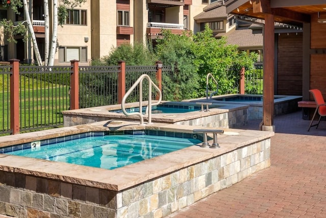 view of swimming pool with a community hot tub